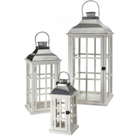 Set of three white lanterns with metallic tops on a white background