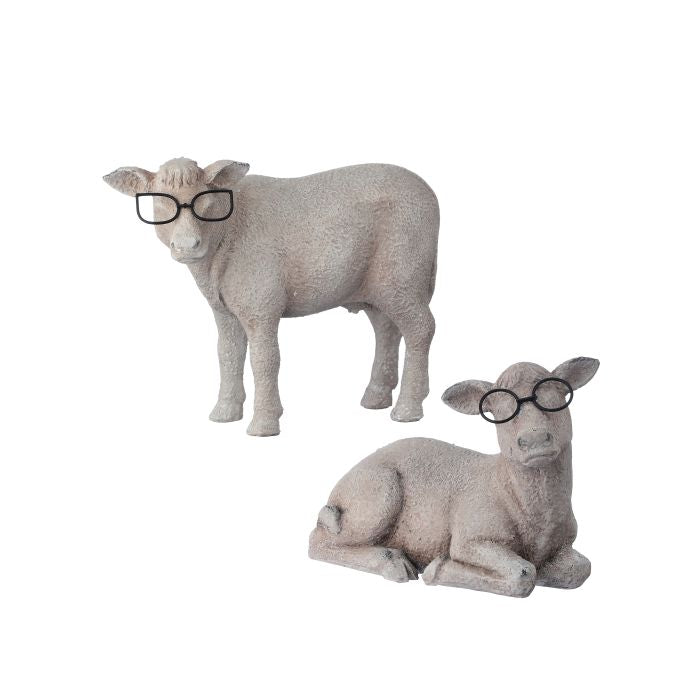 Two stone sheep figurines, one standing and one lying down, both wearing black glasses on a white background.