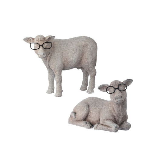 Two stone sheep figurines, one standing and one lying down, both wearing black glasses on a white background.