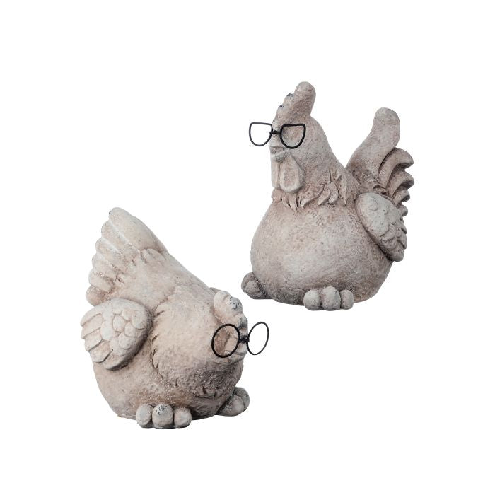 Two stone-like chicken figurines with glasses on a white background