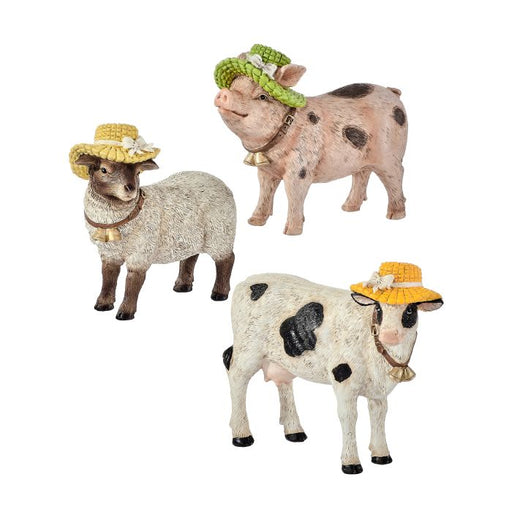 Three animal figurines, including a sheep, pig, and cow, wearing decorative hats on a white background.