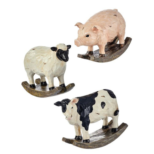 Set of three rocking farm animal sculptures on a white background