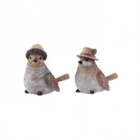 Two small bird figurines wearing hats, shown side by side on a plain white background. One bird wears a brown knit hat and the other wears a straw hat with a green leaf accent.