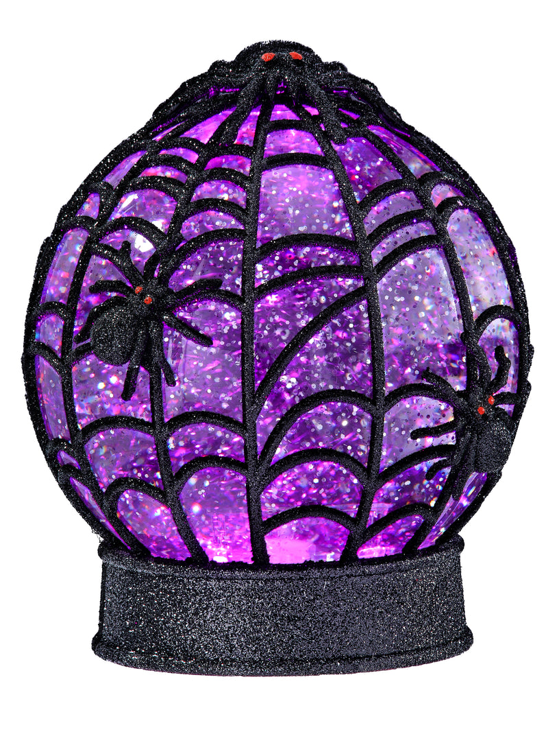 A Halloween decorative globe with a black spiderweb frame and glittery purple interior, decorated with three black spiders with red eyes on a white background.