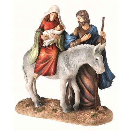 Figurine of a man and woman with a donkey on a white background