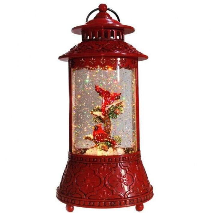 Red lantern-shaped snow globe with a Christmas scene inside on a white background