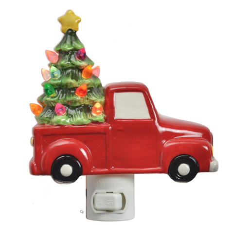 Decorative night light shaped like a red truck with a Christmas tree on a white background
