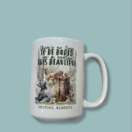 Mug with nature-themed design and text on a light blue background
