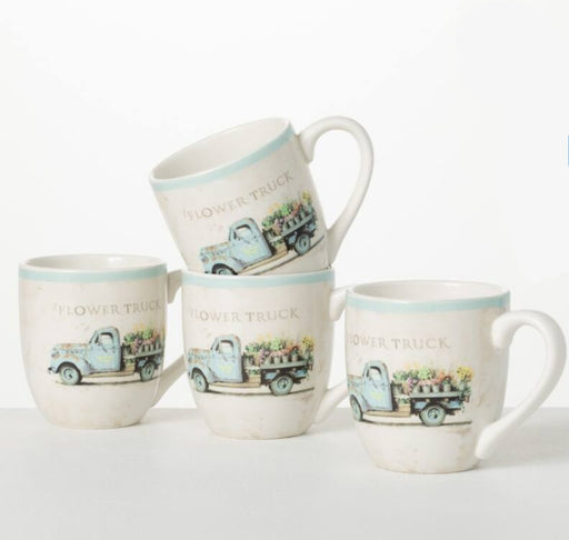Set of four mugs with floral truck design on a white background