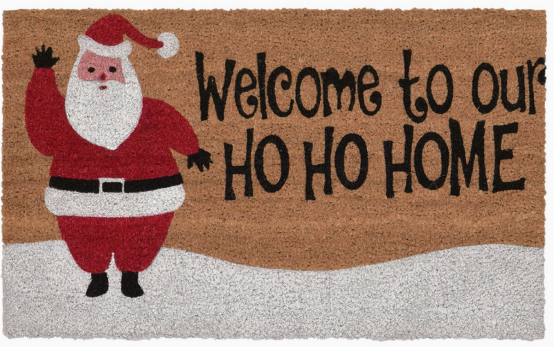 Doormat with Santa Claus illustration and 'Welcome to our HO HO HOME' text on a brown background.