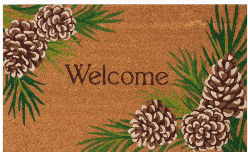 Doormat with pinecones and greenery featuring the word 'Welcome'.