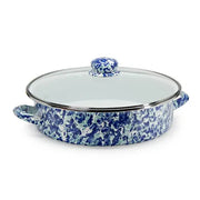 Blue floral-patterned casserole dish with a clear glass lid on a white background