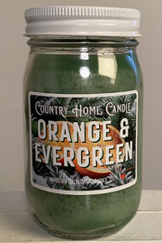 Jar of 'Orange & Evergreen' candle by Country Home Candle on a neutral background