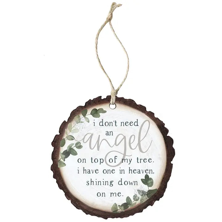 A round wooden hanging ornament with a natural bark edge, featuring a white center printed with the phrase 'i don't need an angel on top of my tree. i have one in heaven.