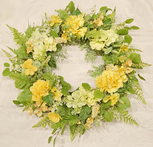 Floral wreath with yellow and green flowers on a textured beige background