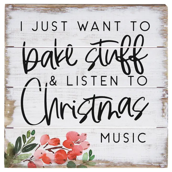 Wooden sign with text 'I just want to bake stuff & listen to Christmas music' and floral design.