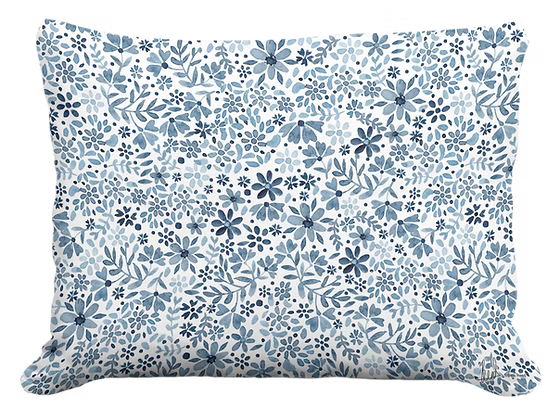 Floral patterned pillow with blue and white design on a white background