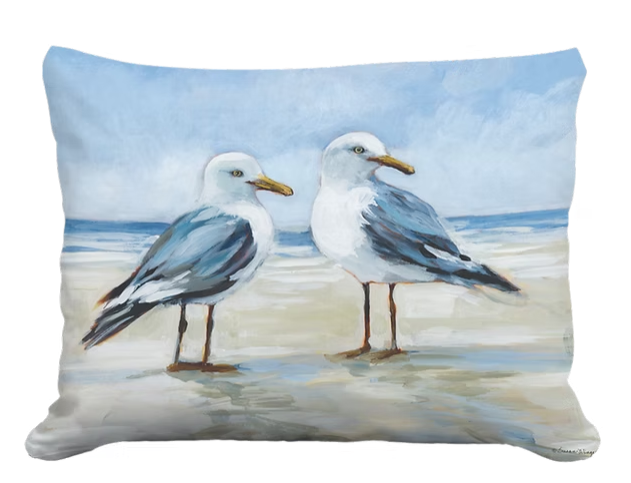 Decorative pillow with two seagulls on a beach scene
