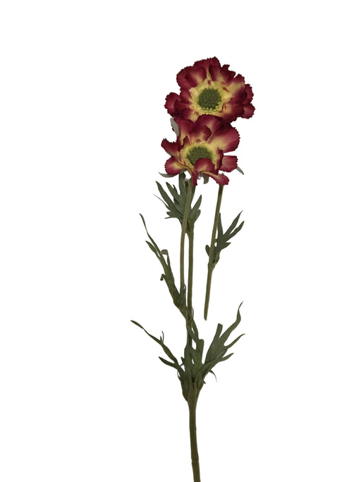 Artificial flowers on a textured white surface