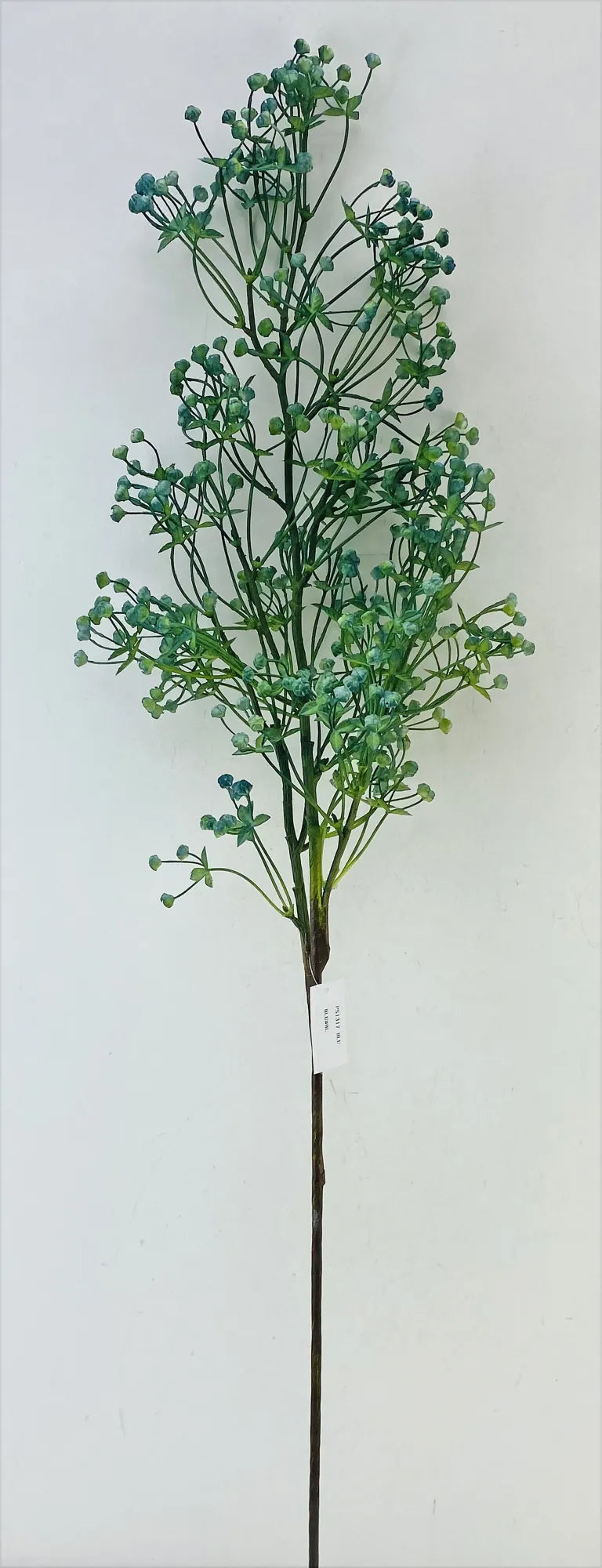 Artificial plant stem with green leaves on a white background
