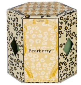 A green Tyler Candle Company jar candle with a decorative lid featuring a leopard print design.