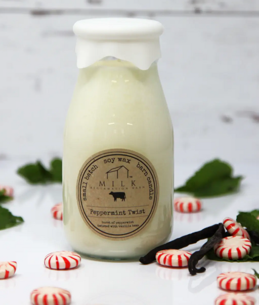Scented candle labeled 'Peppermint Twist' with peppermint candies and vanilla beans on a light background