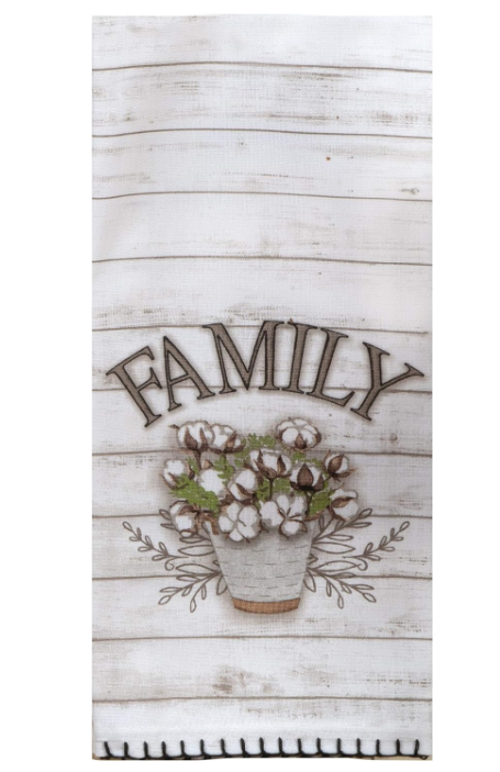 Decorative towel with 'FAMILY' text and floral design on a wooden background