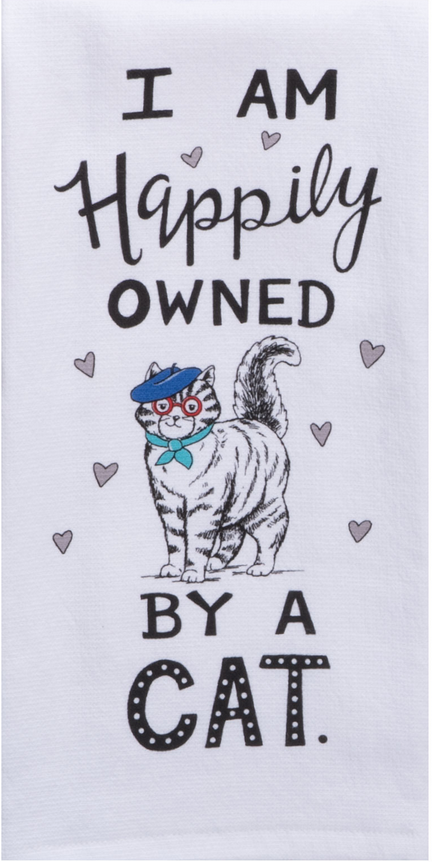 Towel with a cat illustration and text 'I am happily owned by a cat' on a white background
