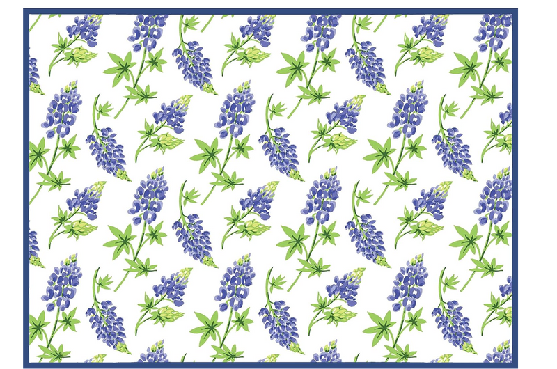 A kitchen dish drying mat featuring a floral pattern with bluebonnet flowers on a white background, with a solid blue border.
