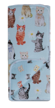 Folded fabric with cat pattern on a light blue background