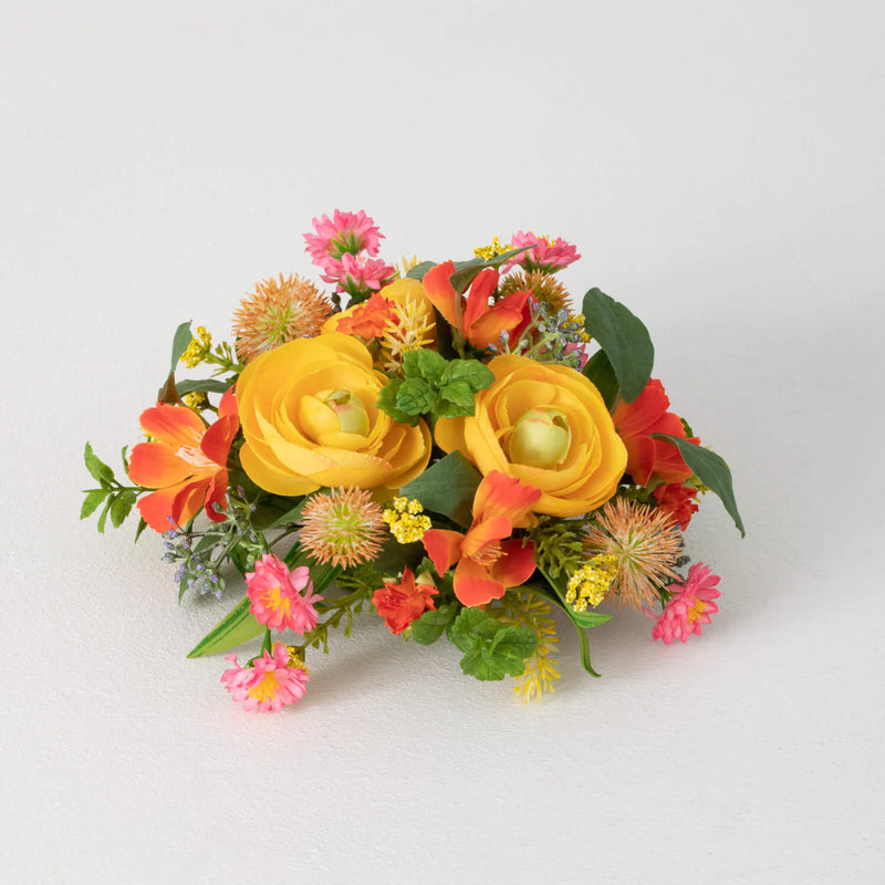 Colorful flower arrangement with yellow, orange, and pink flowers on a white background