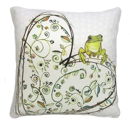 Decorative pillow with a frog and floral patterns on a white background