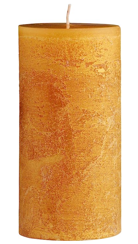 Textured yellow candle on a white background