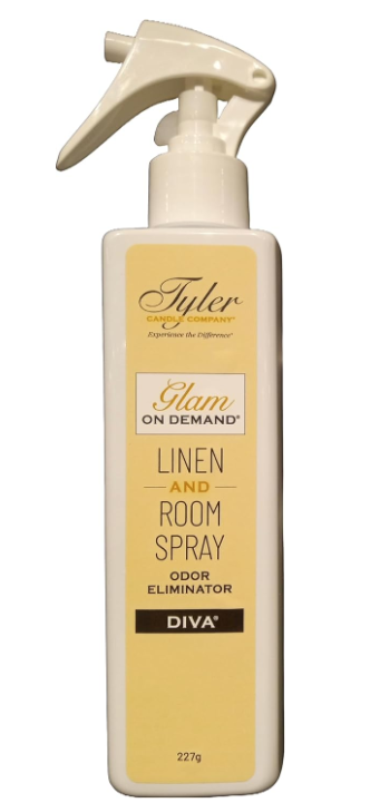 A bottle of Tyler Candle & Co. Linen & Room Spray in 'Diva' fragrance, with a white label and gold accents.