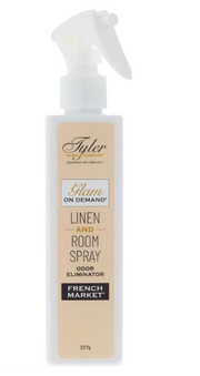 A bottle of Tyler Candle & Co. Linen & Room Spray in 'Diva' fragrance, with a white label and gold accents.