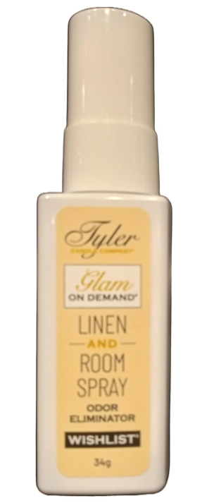 A bottle of Tyler Candle & Co. Linen & Room Spray in 'Diva' fragrance, with a white label and gold accents.