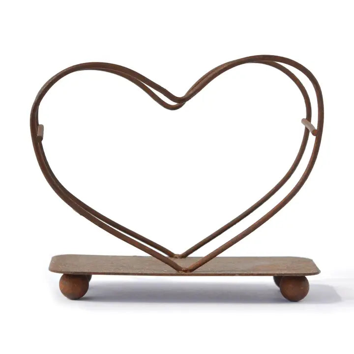 Heart-shaped metal stand with metal base on a white background