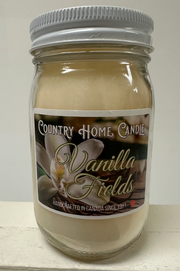 Jar of Country Home Candle Vanilla Fields candle on a white surface with a neutral background