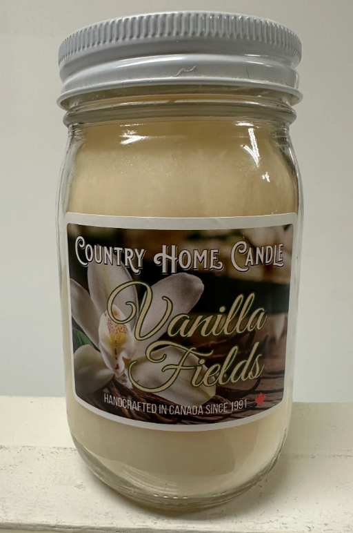 Jar of Country Home Candle Vanilla Fields candle on a white surface with a neutral background