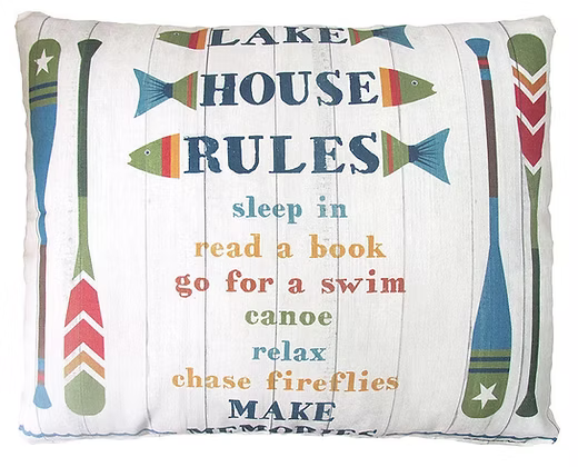 Decorative pillow with 'Lake House Rules' text and illustrations on a white background