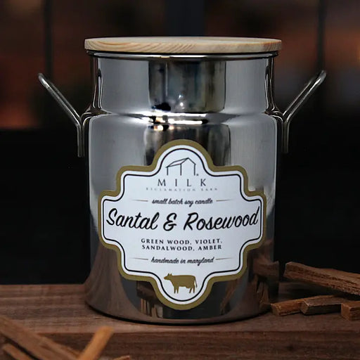 Silver candle jar with 'Milk' label featuring Santal & Rosewood fragrance on a wooden surface.