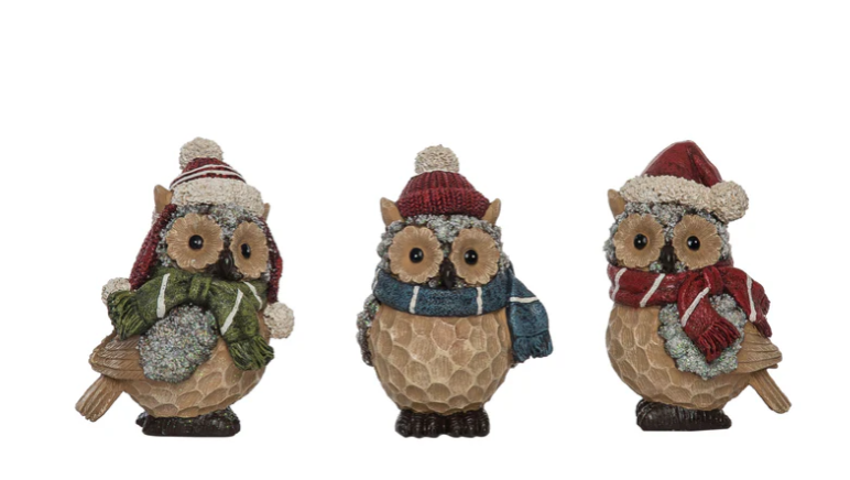 Three decorative owls wearing winter hats and scarves on a white background