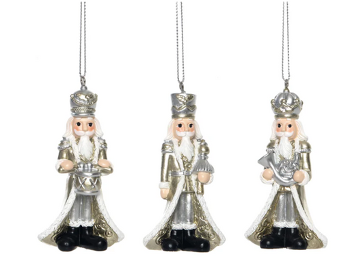 Three decorative nutcracker ornaments on a white background