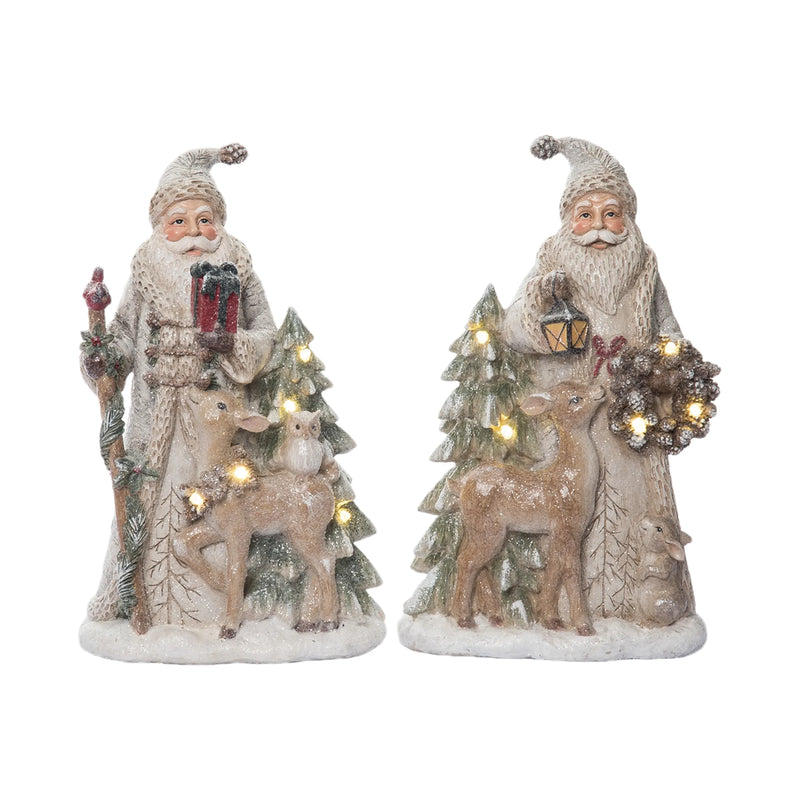 Two decorative figures of Santa Claus with reindeer and trees on a white background
