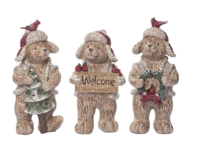 Three decorative bear figurines with winter accessories on a white background