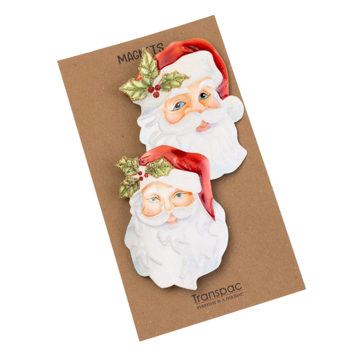 Two Santa Claus magnets on a Transpac packaging with a brown background