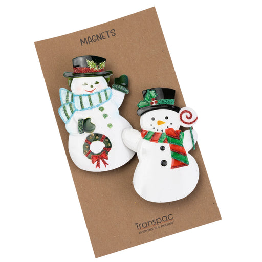 Two decorative snowman magnets on a brown backing card with 'Transpac' branding.