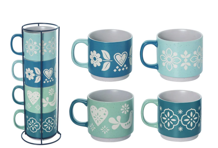 Set of four blue and green mugs with floral and heart patterns, one mug in a stand.