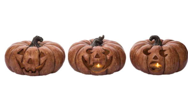 Three wooden pumpkin-shaped lanterns with carved faces on a white background