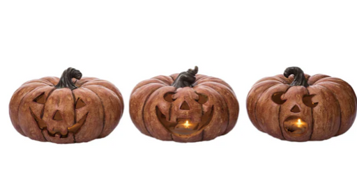 Three wooden pumpkin-shaped lanterns with carved faces on a white background
